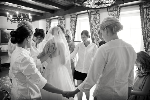 Beautiful photo of friends and family surrounding the bride in prayer - photo by top Atlanta-based wedding photographer Scott Hopkins Photography